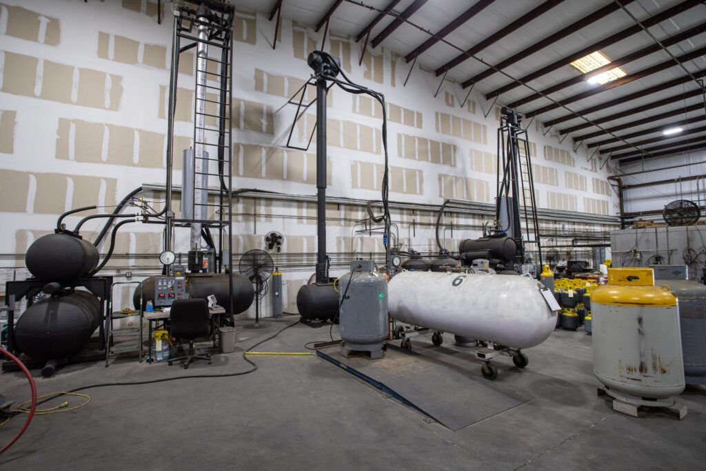 epa-certified-refrigerant-reclamation-facility-sarasota.jpg Alt Text: Industrial fractional distillation towers at American Refrigerants EPA certified reclamation facility ensuring gas purity.