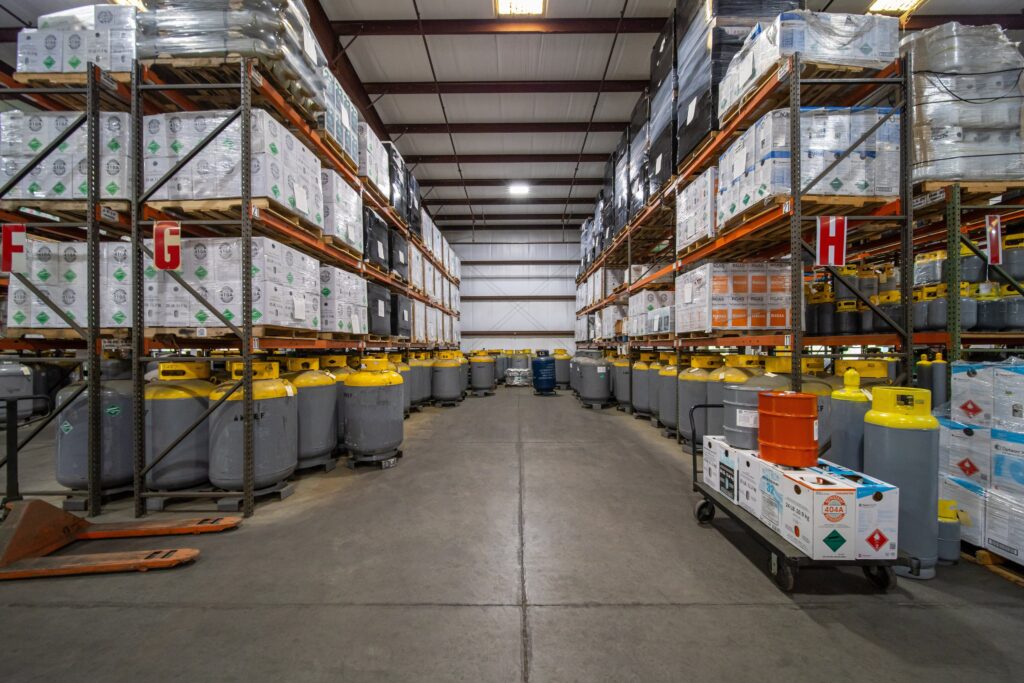 Large inventory of refrigerant cylinders and pallets at American Refrigerants warehouse in Bradenton FL ready for supply.